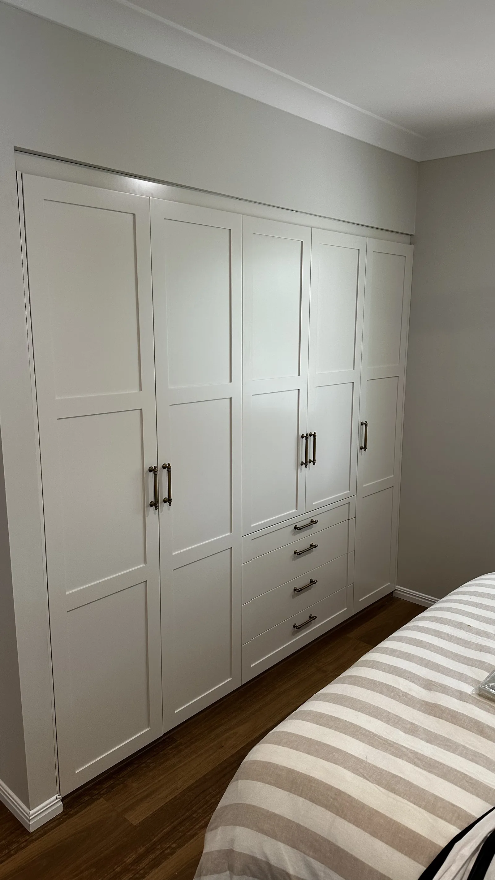 White shaker built-in wardrobe in a bedroom