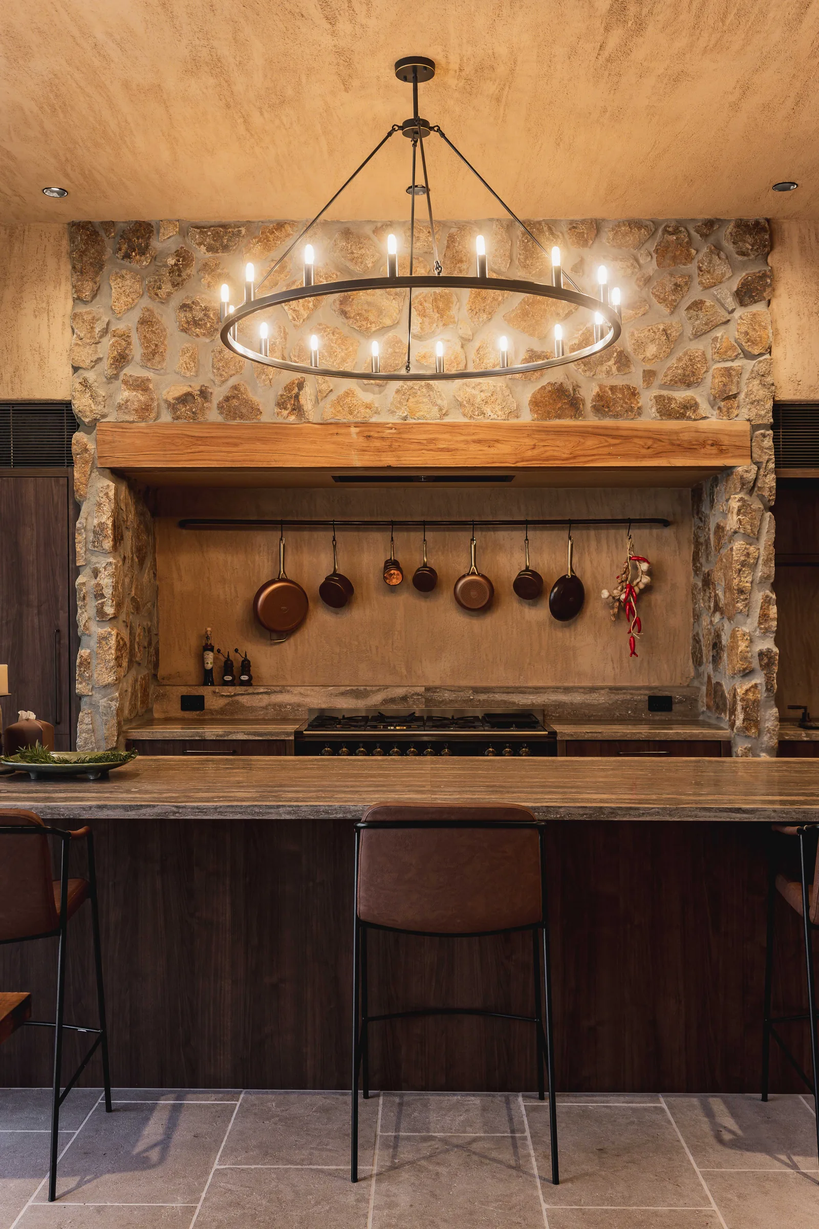 Kitchen with stone benchtop and dark timber cabinetry