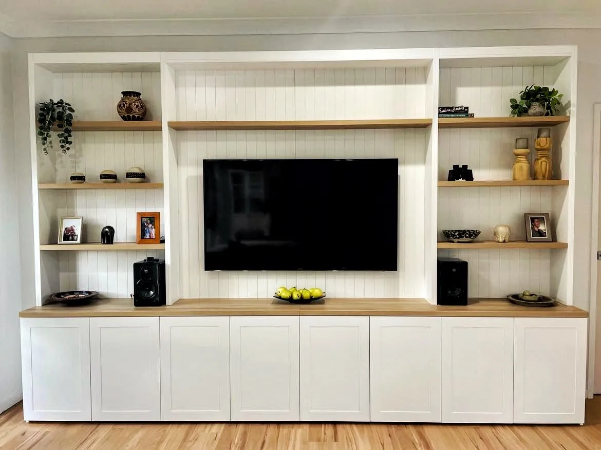 White media wall with open shelving and storage