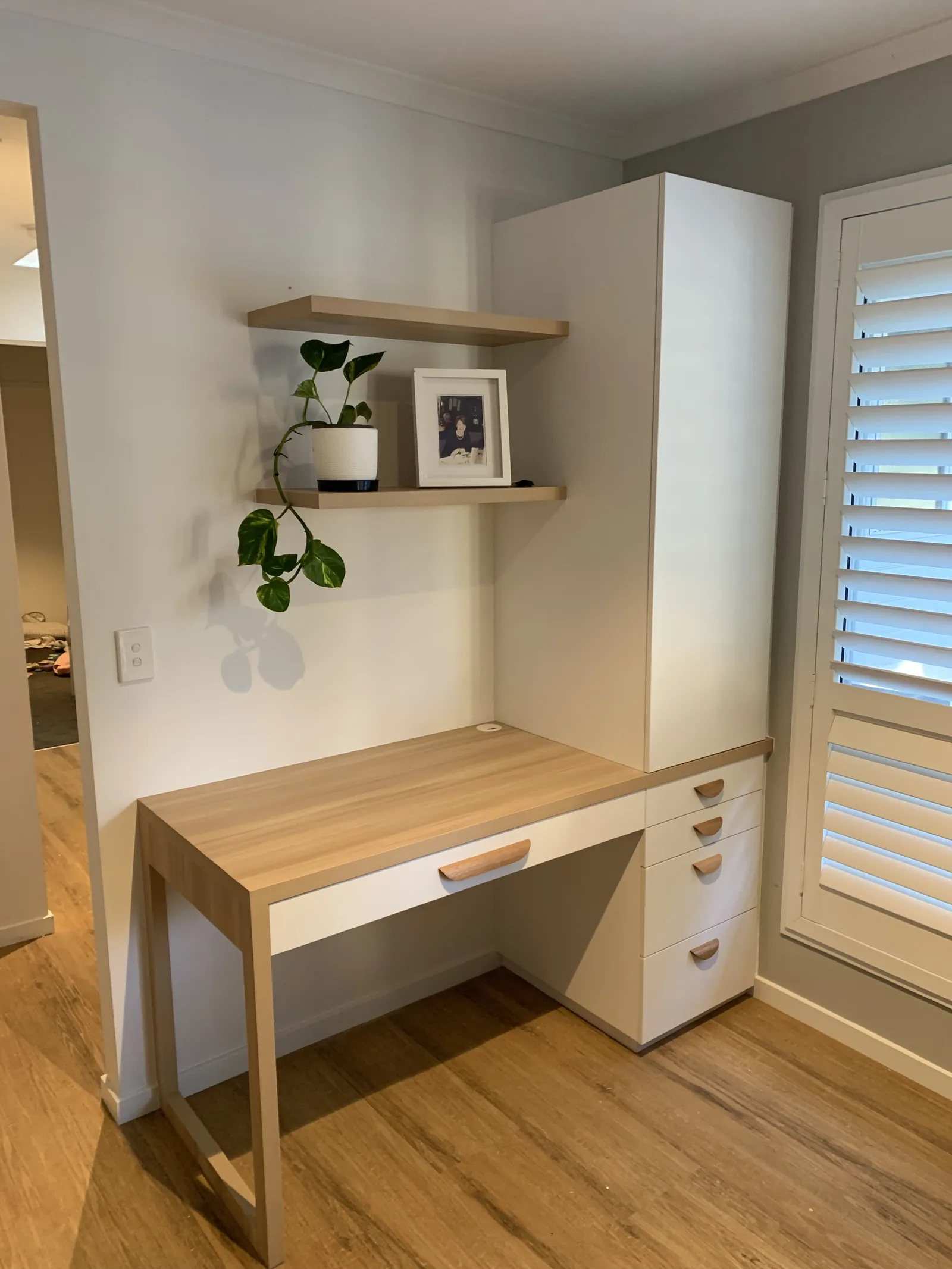 Home office with built-in desk and drawers