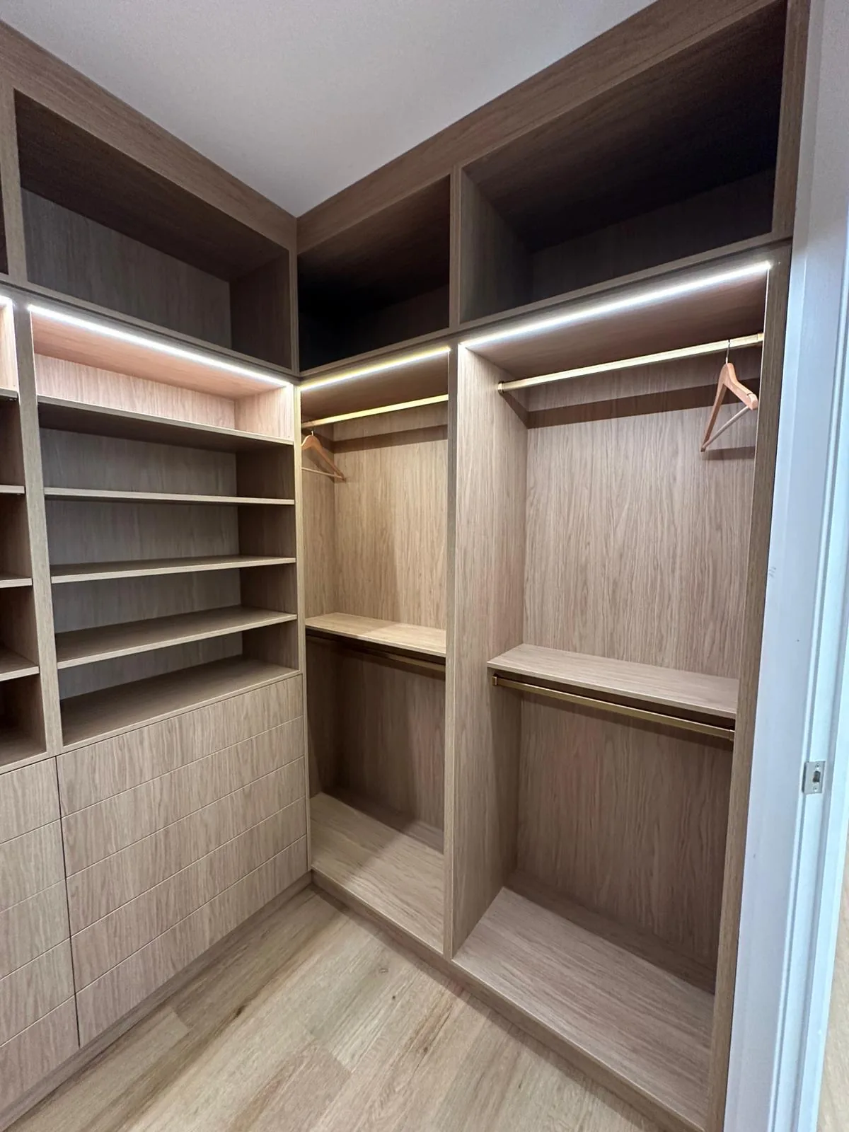 Oak walk-in robe with LED shelving and hanging space