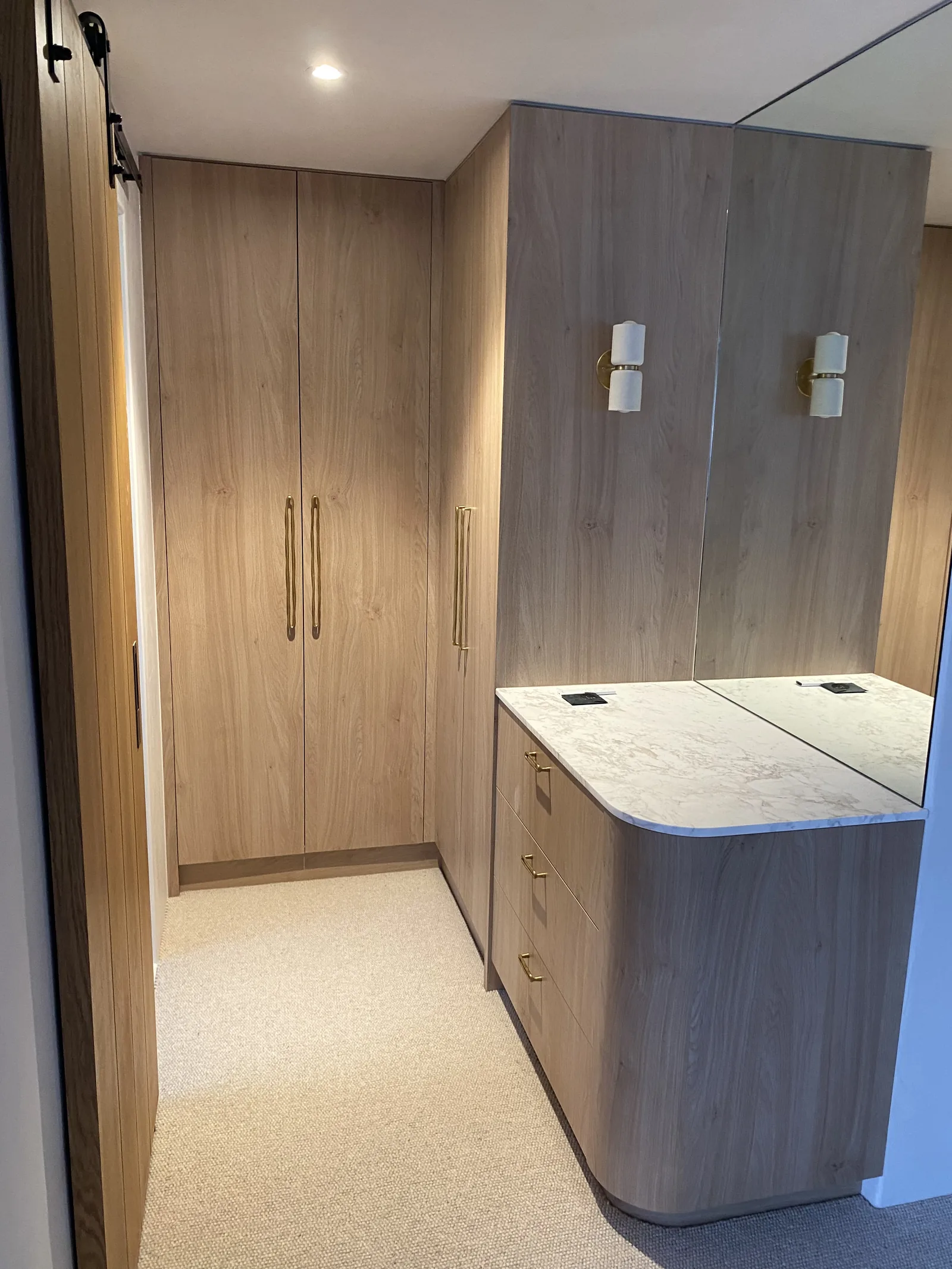 Walk-in robe with stone-top island and full-height mirror